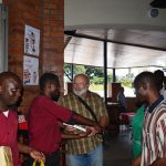 Mr Green giving Bibles to workers at Shopping Mall